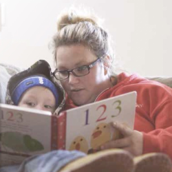 Woman reading a book to a child